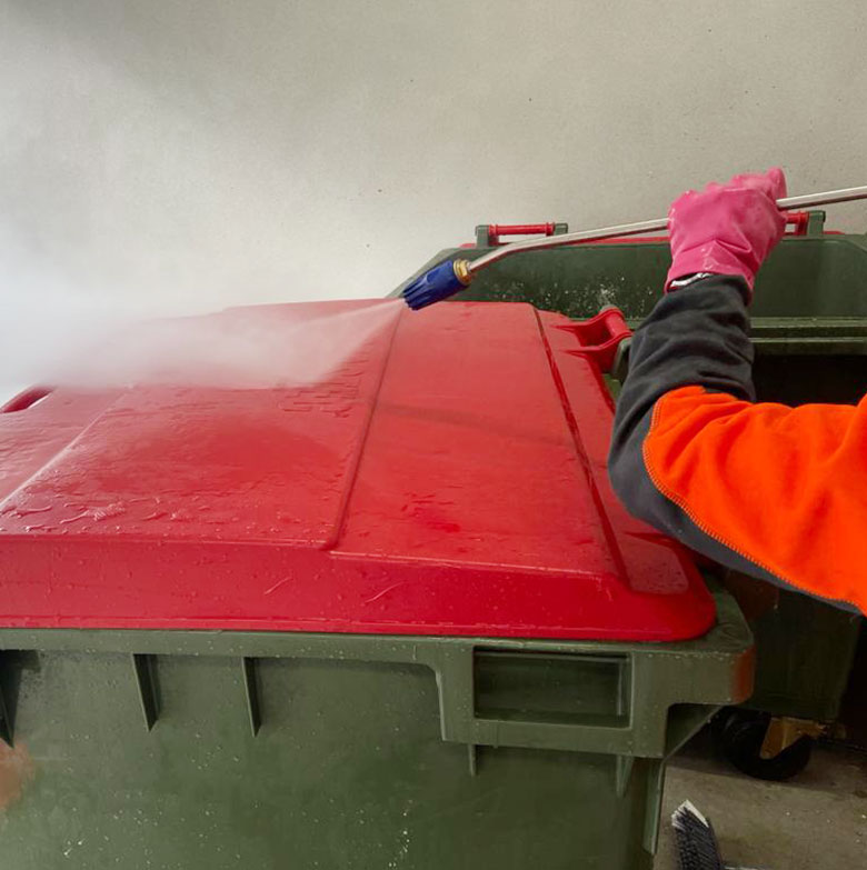 Cleaning a dirty commercial trash bin in Melbourne