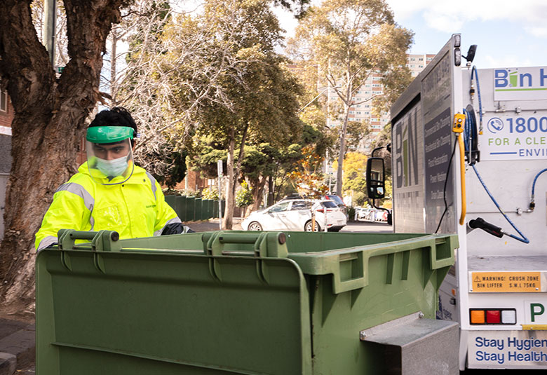 Placing the bins at the designated area after cleaning them