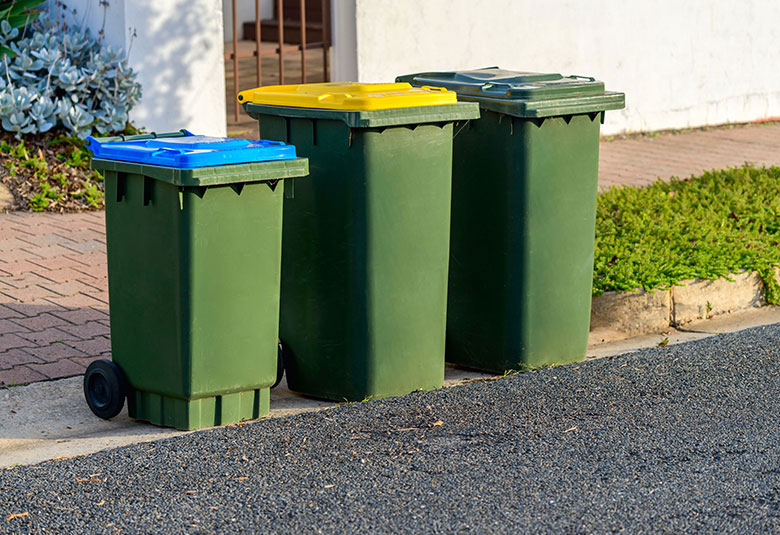 Placing the residential bins at the curbside after washing, disinfecting and deodorizing them